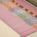 A file cabinet with pink Smead letter size file folders.