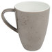 A close-up of a light gray Schonwald porcelain coffee mug with a speckled design.