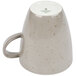 A light gray Schonwald porcelain coffee cup with a speckled design.