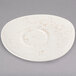 A Schonwald white porcelain saucer with brown speckles.