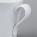 A Schonwald white porcelain espresso cup with a curved handle.