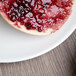 A bagel with jam on a Schonwald round porcelain plate.
