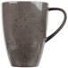 A close up of a dark gray Schonwald porcelain mug with a speckled design.