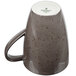 A dark gray porcelain mug with a brown speckled design and a handle.