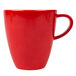 A red porcelain coffee mug with a speckled black pattern and a red handle.