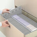 A person opening a file drawer with Smead TUFF hanging file folders inside.