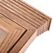 A close up of the natural oak frame on an Aarco bulletin board.