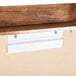 A close-up of a wooden bulletin board with a crown molding.