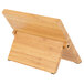 A Mercer Culinary bamboo tablet stand with a wooden board and black handle.