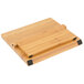 A Mercer Culinary bamboo cutting board with black handles.