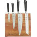 A Mercer Culinary Z&#252;M 5 piece knife set on an acacia magnetic board.