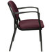 A Eurotech Dakota series burgundy arm chair with black frame and armrests.