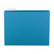 A teal Smead hanging file folder with a white repositionable poly tab.