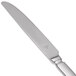 A Libbey stainless steel dessert knife with a pinched bolster and a serrated edge with a solid silver handle.
