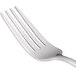 A close-up of a World Tableware stainless steel utility/dessert fork with a silver handle.
