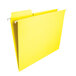 A close-up of a yellow Smead FasTab file folder with white clips.