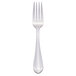 A silver dessert fork with a white column handle.