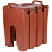A brick red Cambro insulated beverage dispenser with a handle.