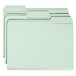 A stack of Smead file folders with green tabs.
