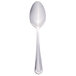 A stainless steel dessert spoon with a white handle.