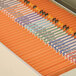 A file cabinet drawer filled with Smead orange file folders with reinforced tabs.