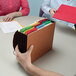 A person holding a Smead expansion wallet with colorful files inside.