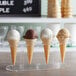 A JOY ice cream cone filled with white ice cream.