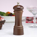 A Chef Specialties walnut pepper mill on a table.