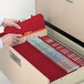 A person opening a file cabinet drawer with Smead Heavy Weight Letter Size Classification Folders inside.