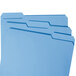 Three blue Smead file folders with assorted tabs.