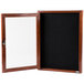 A wooden frame with a cherry finish and a black felt message board behind a glass door with a lock.