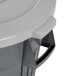 A close-up of a gray Continental round trash can with a gray lid.