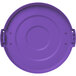 A Carlisle purple plastic lid with a handle on it for a round trash can.