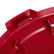 A red Carlisle flat round lid for a 32 gallon plastic trash can.