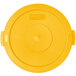 A yellow plastic lid with a small dot in the center.