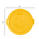 A yellow plastic lid with a handle.