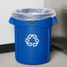 A blue Rubbermaid Brute recycling can with a plastic bag inside.