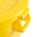 A close up of a yellow Continental Huskee round plastic trash can with a yellow lid.