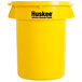 A yellow Continental Huskee round trash container with a yellow lid and black text.