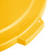 A yellow plastic Carlisle Bronco lid for a round trash can.
