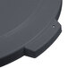 A close up of a Carlisle grey flat round trash can lid with a black handle.