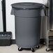 A grey Carlisle Bronco trash can lid on a grey trash can.