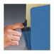 A hand with a finger touching a blue Smead file pocket.
