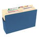 A blue Smead file pocket with a label and several documents inside.