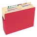 A red Smead file pocket with a label and several files inside.