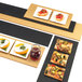A black rectangular Cal-Mil bread serving board with food on it.