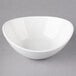 A white 10 Strawberry Street Whittier porcelain boat bowl on a gray surface.
