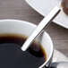A Chef & Sommelier Kya stainless steel demitasse spoon in a cup of coffee.