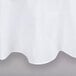 A white Intedge poly/cotton blend table cover with a hemmed edge.
