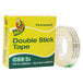 A roll of Duck brand clear permanent double-stick tape in a yellow and green box.